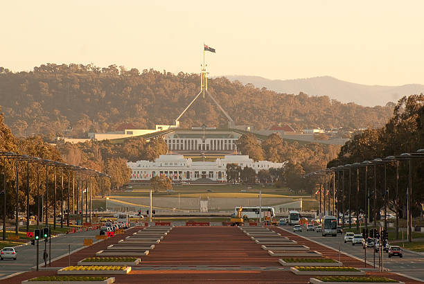 "The old and new parliament houses of Australia, seen down Anzac Parade in...